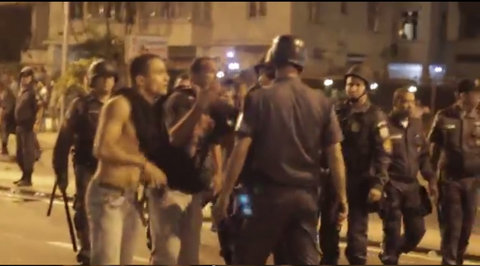 A still frame from video recorded by a witness to clashes on Monday night in Rio de Janeiro appeared to show two undercover officers in jeans and T-shirts retreating behind police lines.